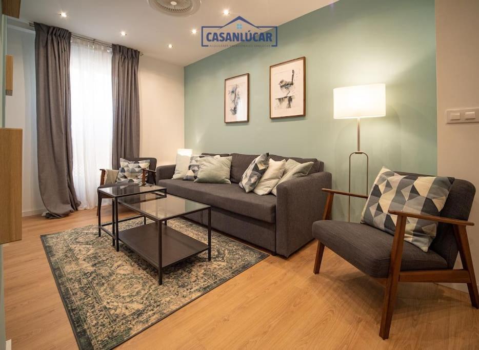 a living room with a couch and a chair at Casa Alcoba de la luz in Sanlúcar de Barrameda