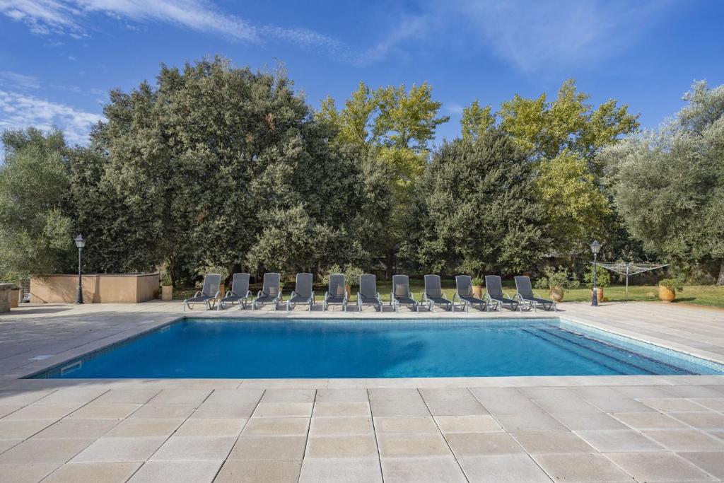 a swimming pool with lounge chairs and a swimming pool at Finca Sa Mina Family in El Port de la Selva