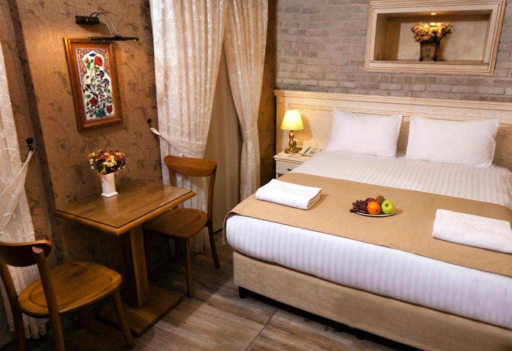 a bedroom with a bed with a bowl of fruit on it at Sultanahmet Suites in Istanbul