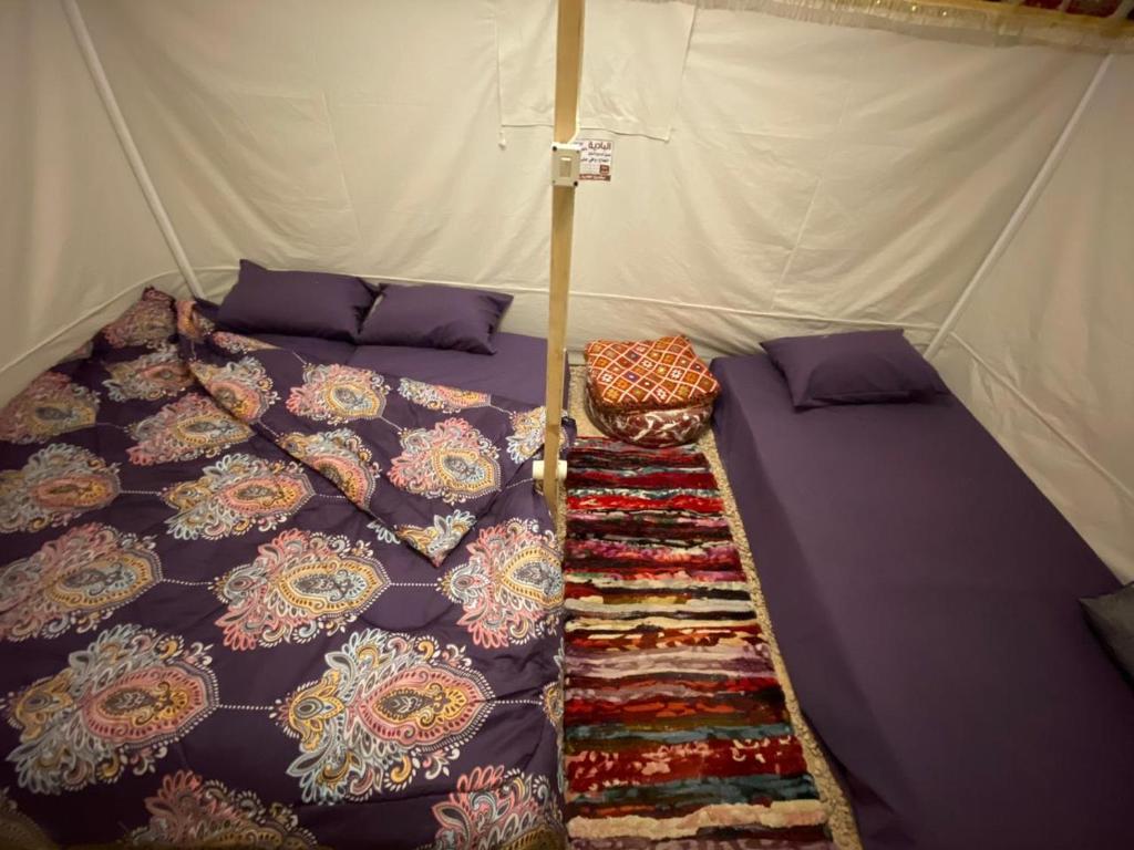 a bed in a tent with umbrellas on it at Muhra in Siwa