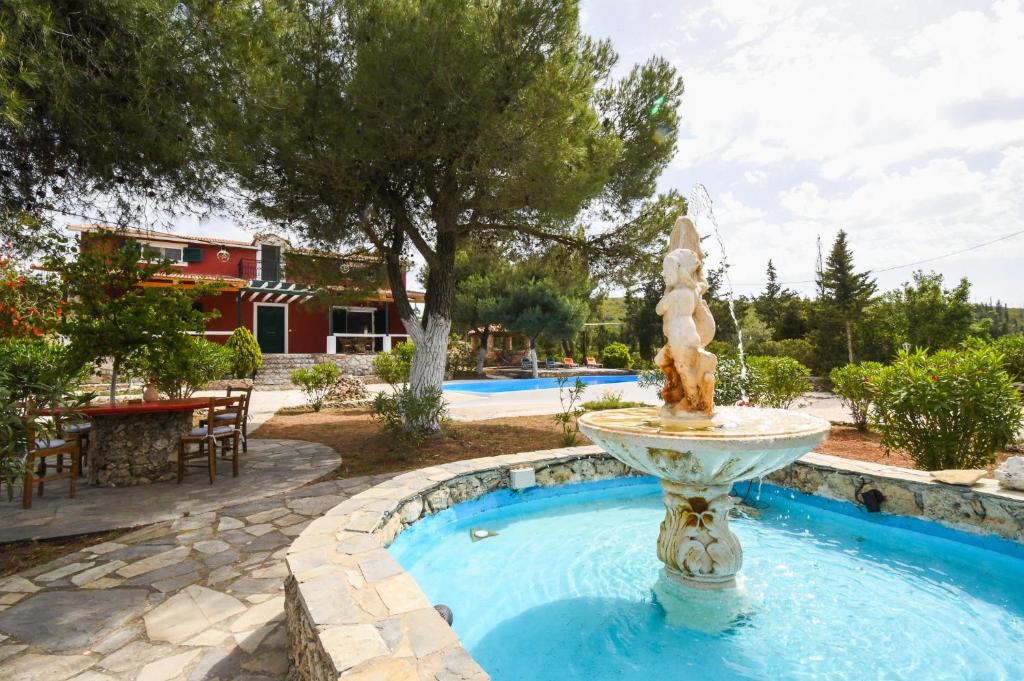 a fountain in the middle of a pool at Elatia Villa in Volímai