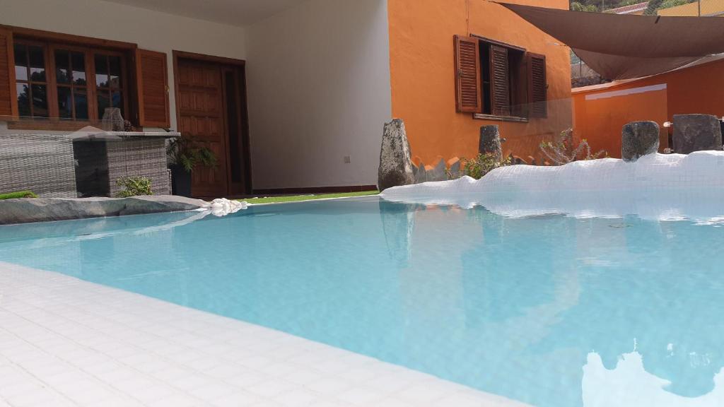 a large blue swimming pool in front of a building at El Pinar in Icod de los Vinos