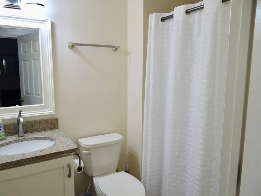 a bathroom with a white shower curtain and a toilet at Deerfield Plantation 217A2 in Myrtle Beach