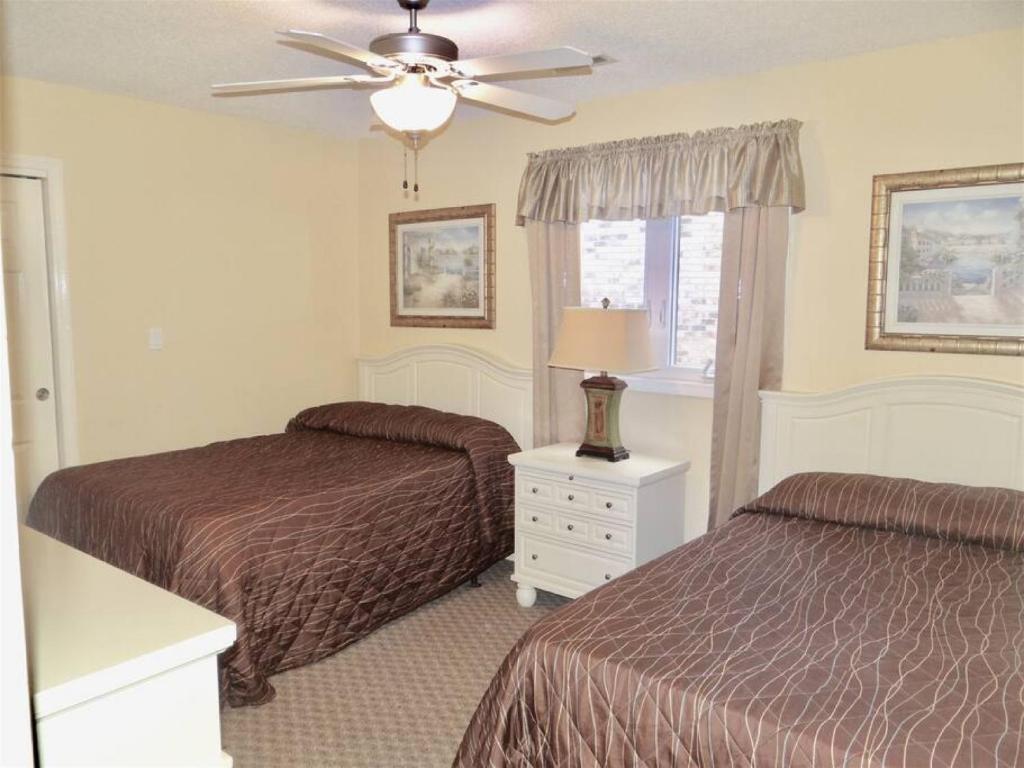 a bedroom with two beds and a ceiling fan at Deerfield Plantation 217A2 in Myrtle Beach