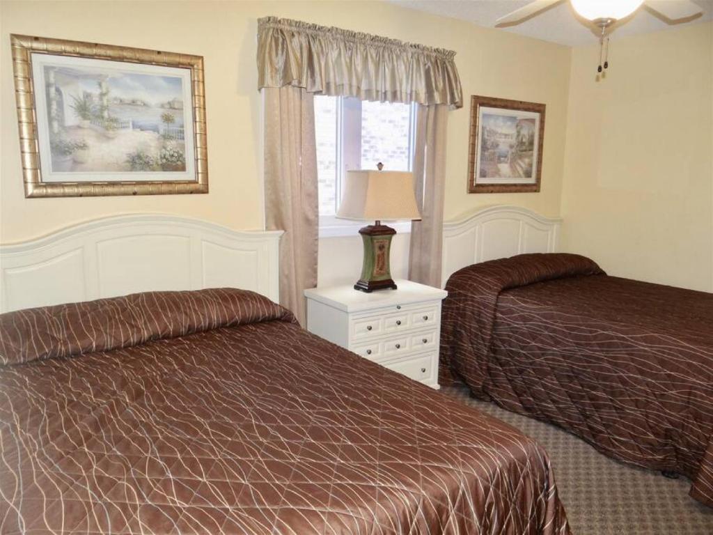 a hotel room with two beds and a window at Deerfield Plantation 217A2 in Myrtle Beach
