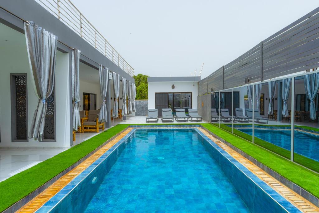 a villa with a swimming pool in a resort at ChezBabo Wellness Hotel in Ngaparou