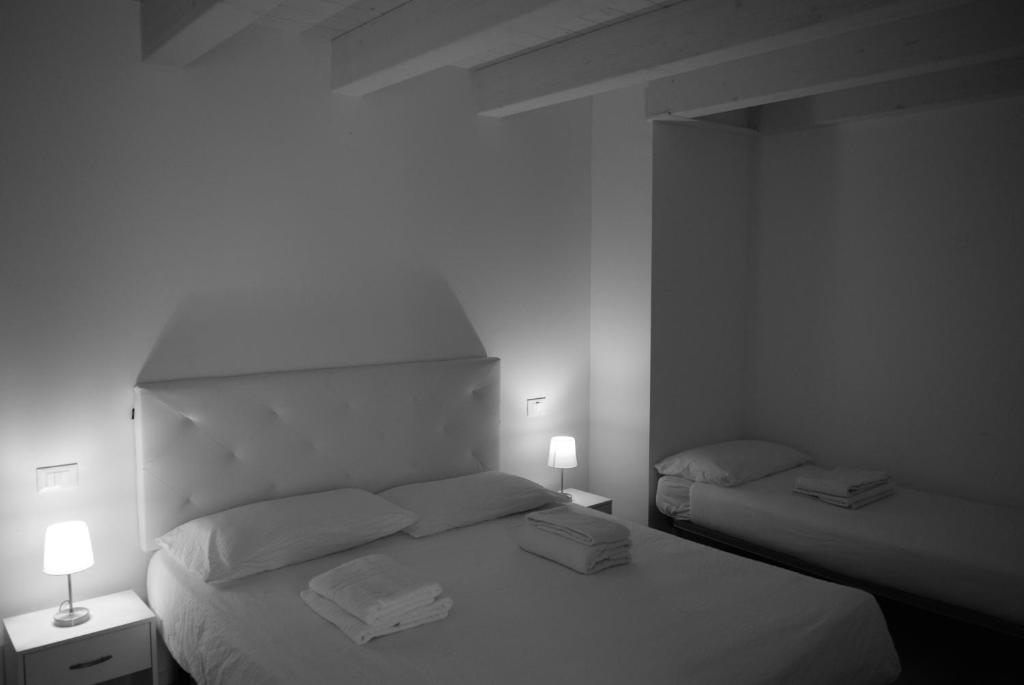 a black and white photo of a bedroom with two beds at Villa AMARE in Caorle