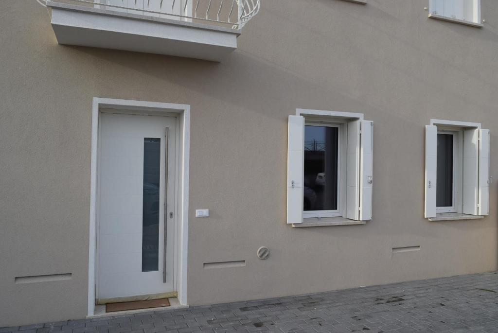 a building with three windows and a door at Villa AMARE in Caorle