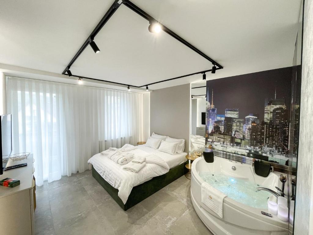 a bedroom with a bath tub and a bed and a bath tub at President Lux Apartment in Pale