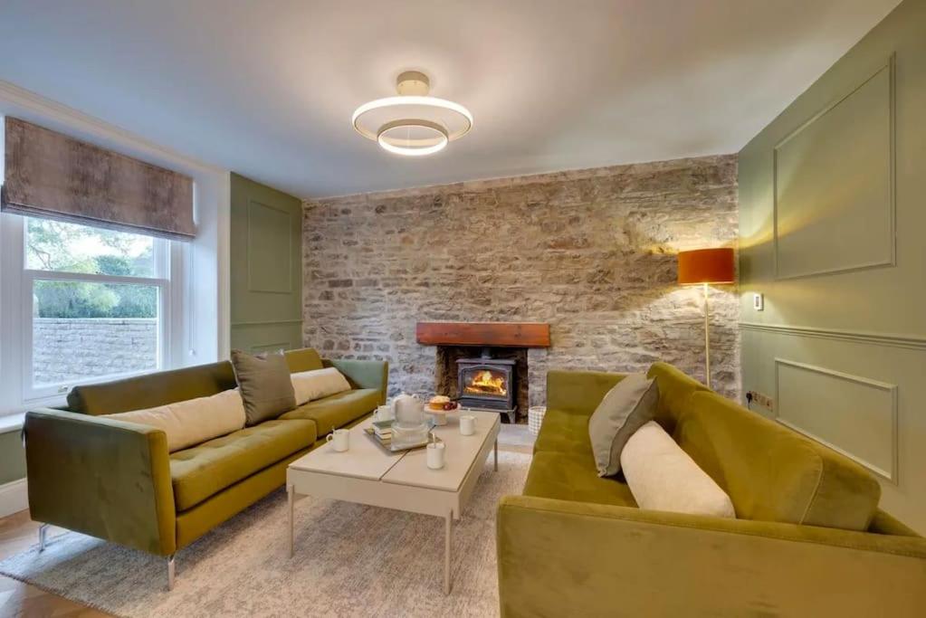 a living room with two couches and a fireplace at Newly renovated 4 Bedroom Cottage with Wood Burner in Aysgarth