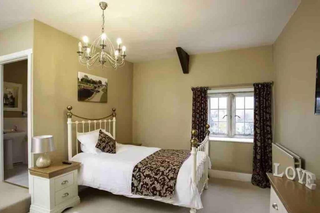 a bedroom with a white bed and a chandelier at Medieval 5 Bedroom House in Stanhope Old Hall in Stanhope