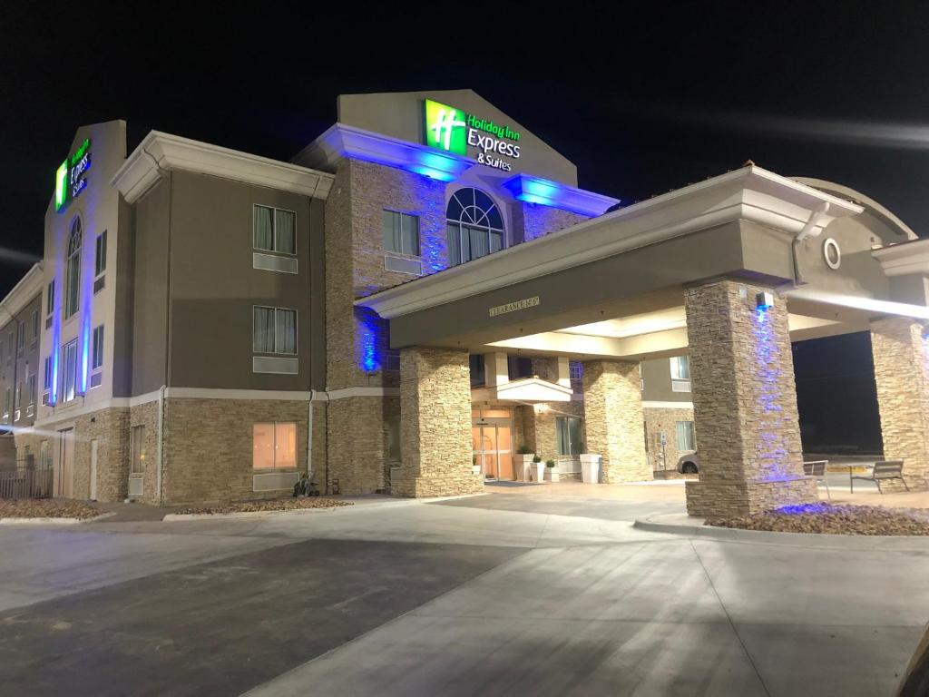 a hotel building with blue lights in the night at Holiday Inn Express Hotel & Suites Woodward Hwy 270, an IHG Hotel in Woodward