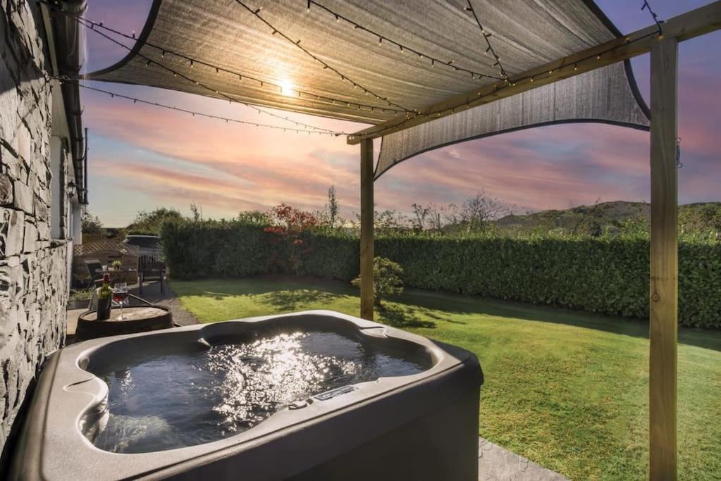 een hot tub in een tuin onder een pergola bij Scar View - Getaway for Two in Underbarrow