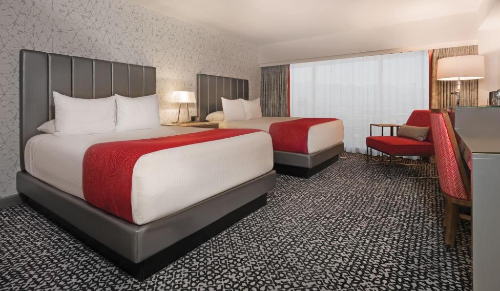 a hotel room with two beds and two lamps at Flamingo Las Vegas Hotel & Casino in Las Vegas