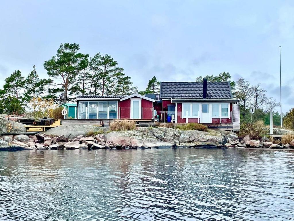 a house on the shore of a body of water at Holiday home OSKARSHAM III in Oskarshamn