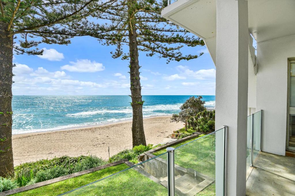 a view of the beach from the balcony of a house at Beachside at The Entrance in The Entrance