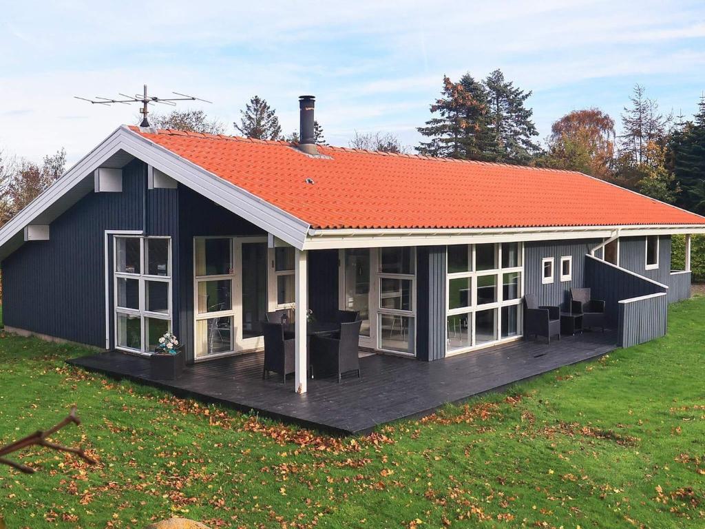 a large blue house with an orange roof at Three-Bedroom Holiday home in Hemmet 30 in Humble
