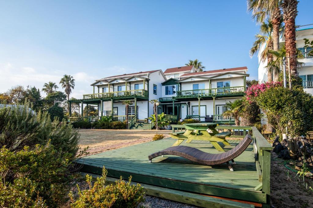 a large house with palm trees in front of it at Euro House in Seogwipo