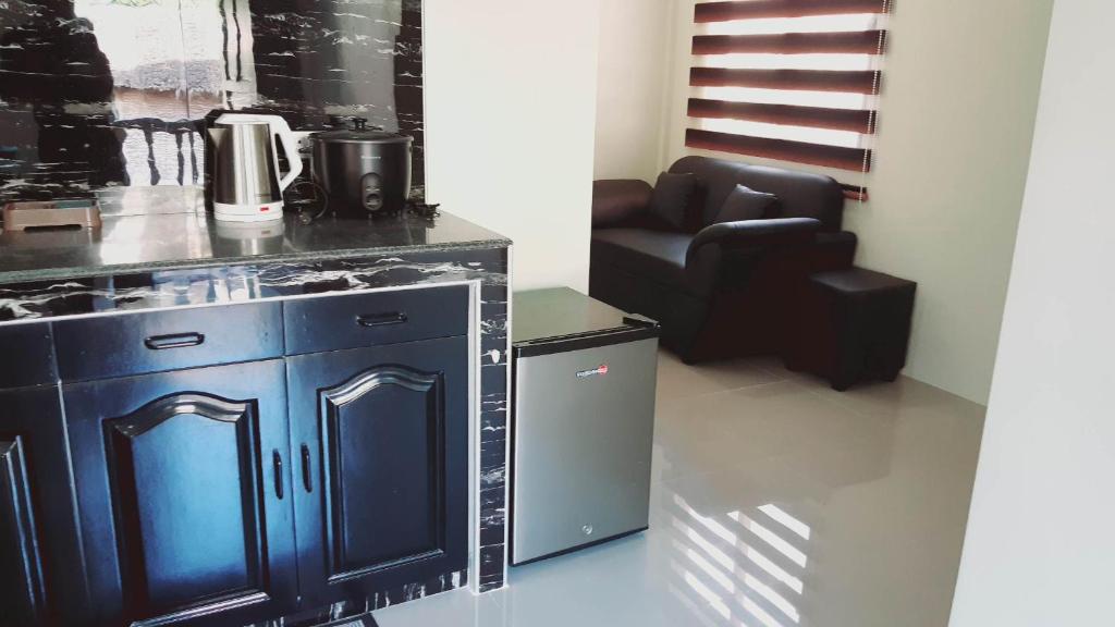 una cocina con armarios azules y una silla en una habitación en Avana Hills Boracay Prime Grand Suite en Boracay
