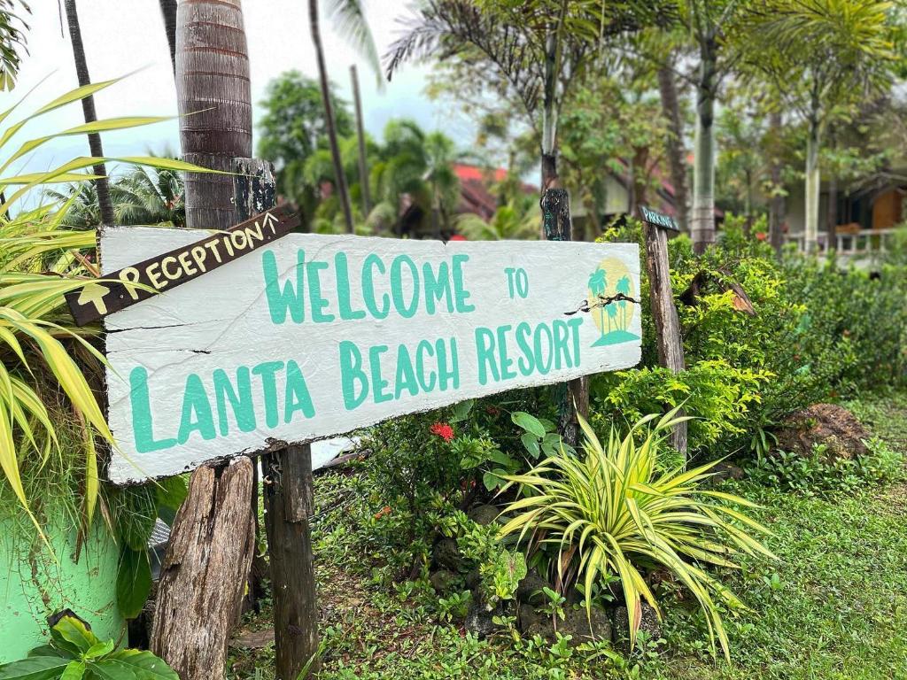 a sign that reads welcome to lanta beach resort at Lanta Beach Resort in Ko Lanta