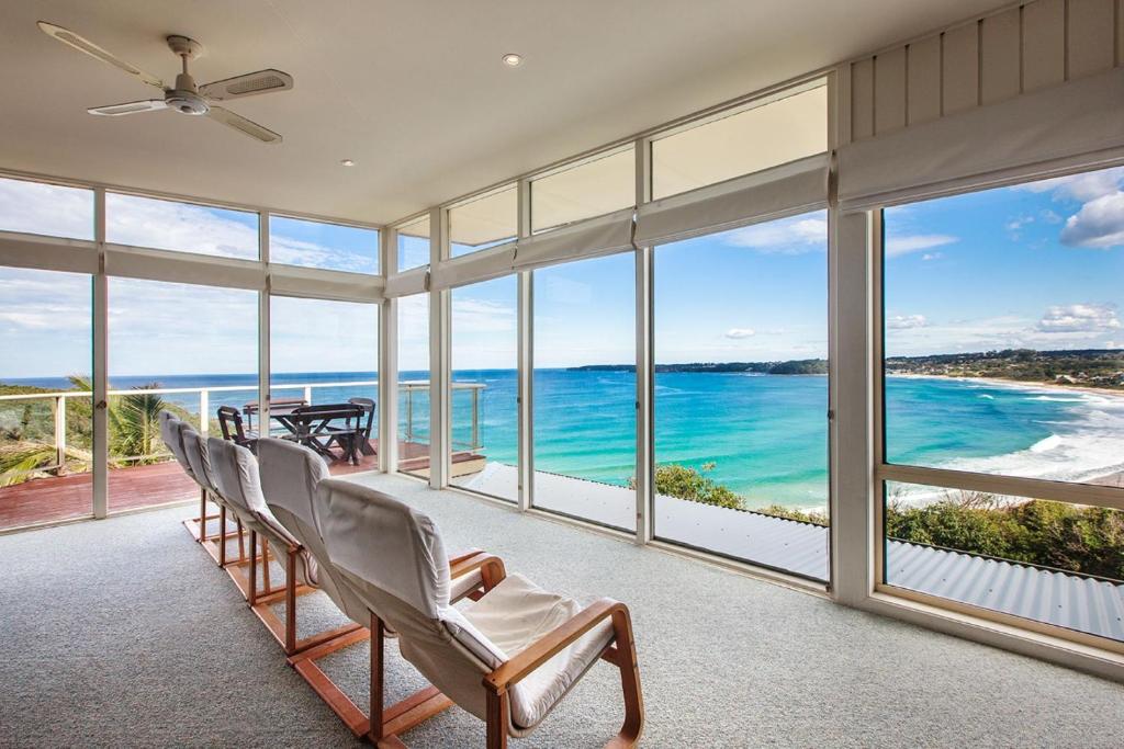 a living room with chairs and a view of the ocean at Spectacular Views in Mollymook