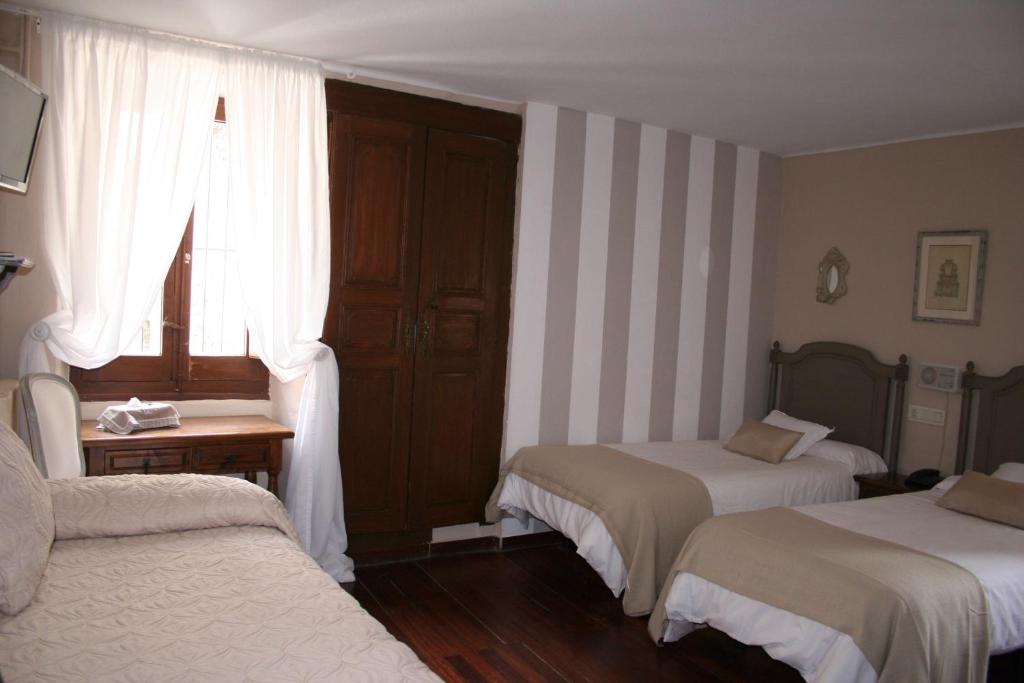 Postel nebo postele na pokoji v ubytování Hotel Boutique Balaitus