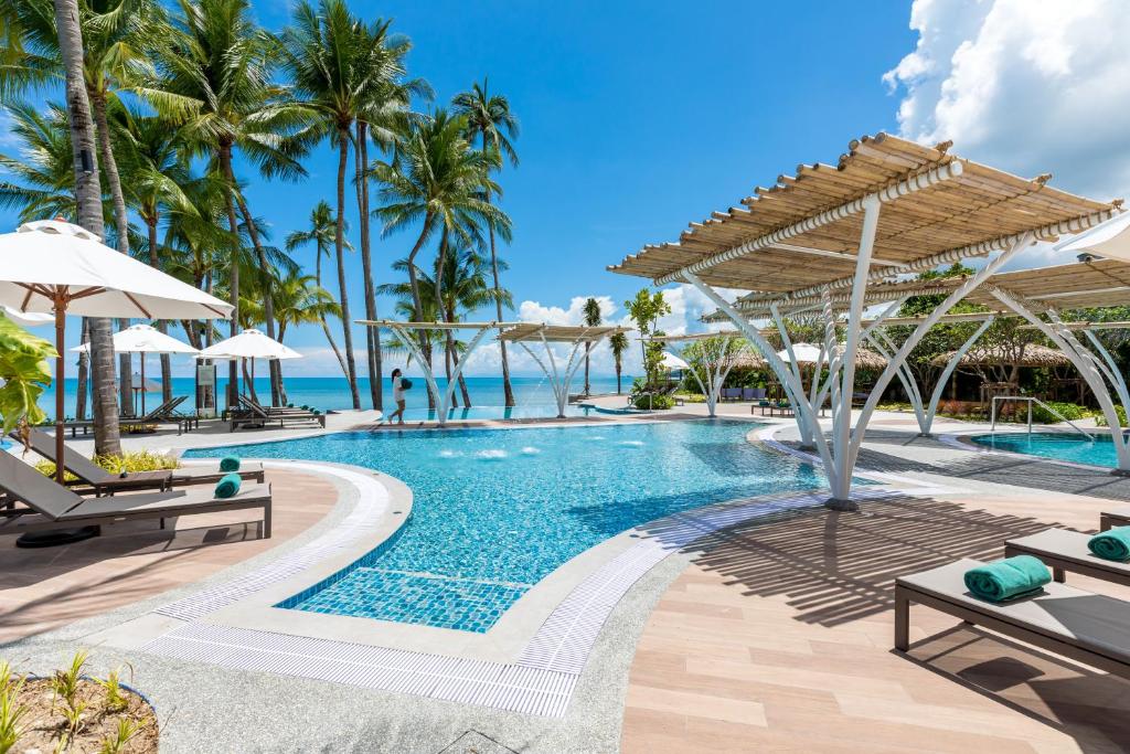 a pool at the excellence punta cana resort at Outrigger Koh Samui Beach Resort - SHA Extra Plus in Lamai