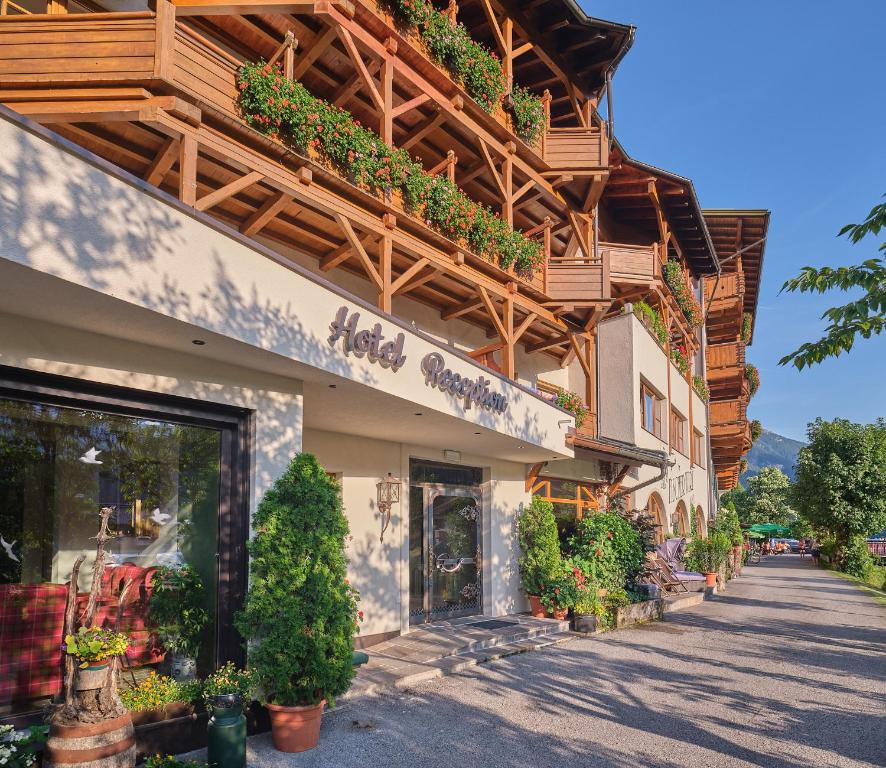 a store with potted plants on the side of a building at Fischerwirt am See in Achenkirch