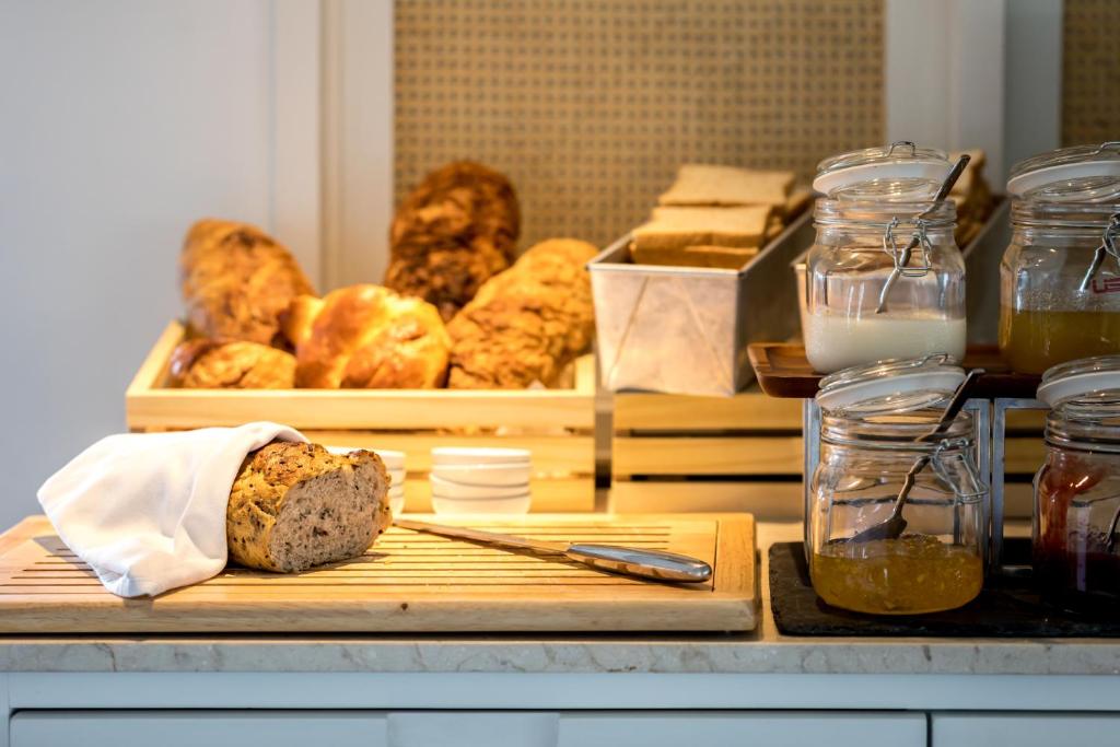a cutting board with a loaf of bread and other pastries at Outrigger Koh Samui Beach Resort - SHA Extra Plus in Lamai