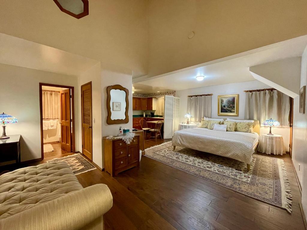 a bedroom with a bed and a living room at Bath Street Inn in Santa Barbara
