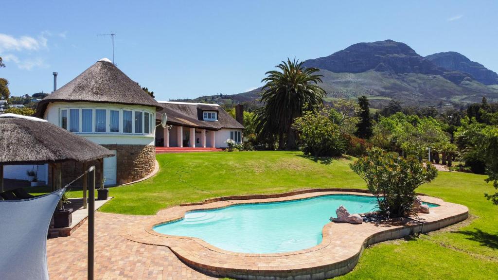 a house with a swimming pool in the yard at La Felicita Boutique Self Catering Villas in Somerset West