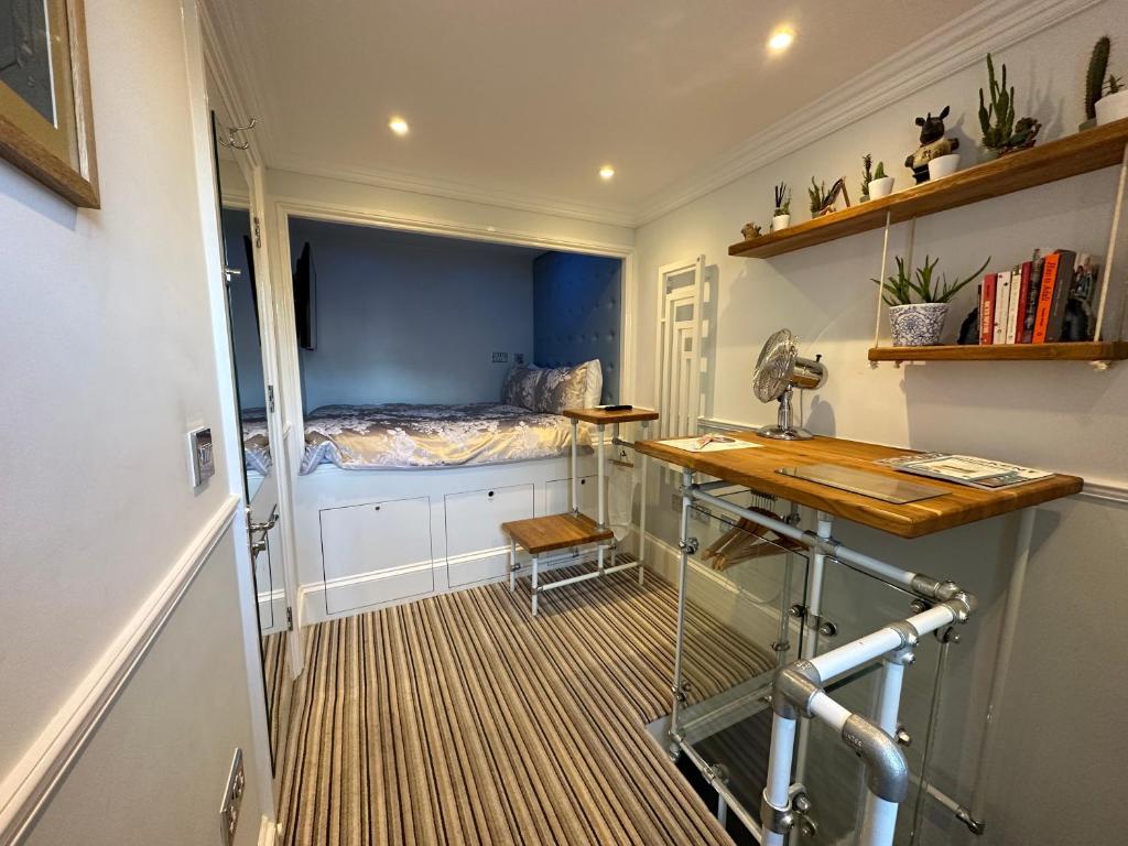 a room with a bed and a desk in it at The Beetroot in Margate