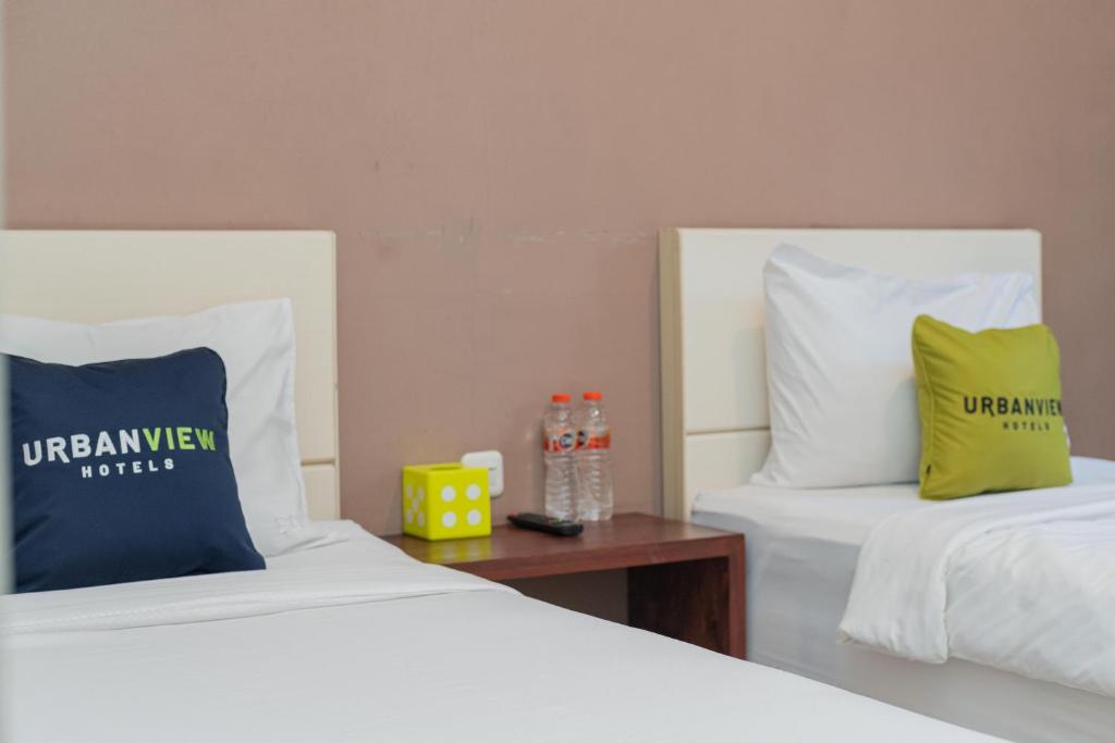 Letto o letti in una camera di Urbanview Hotel Bubusini Batu by RedDoorz