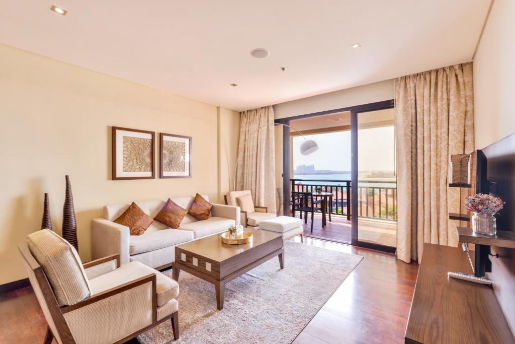 sala de estar con sofá y mesa en Luxury 5-star Palm Resort, en Dubái