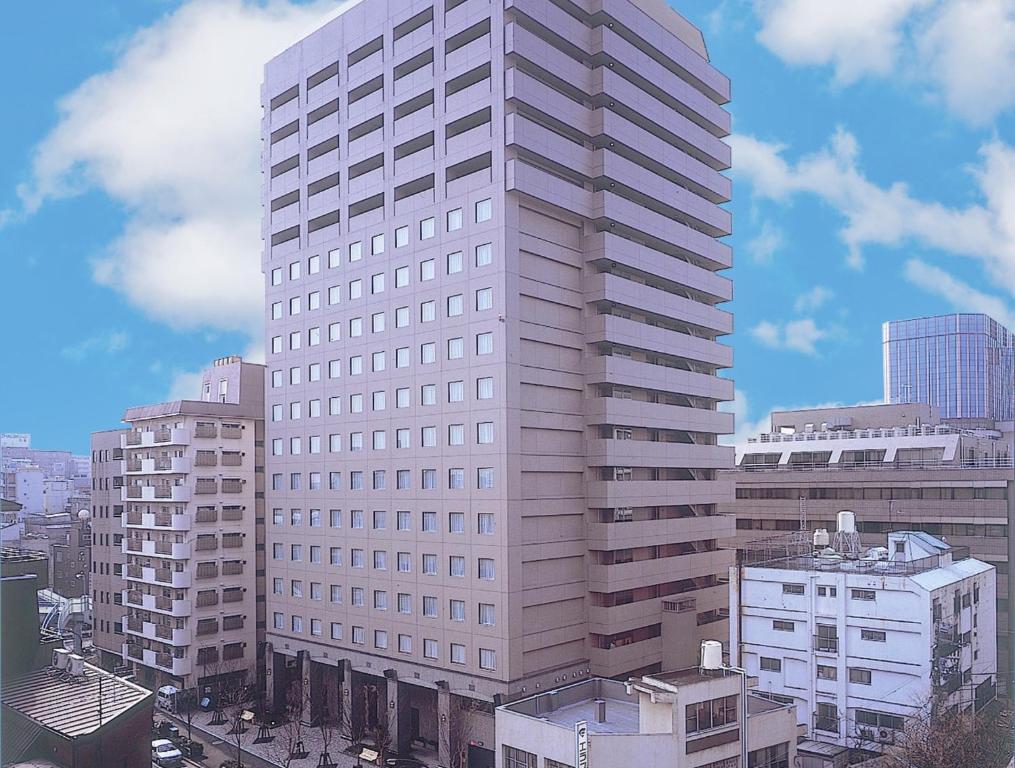a large building with a large building behind it at HOTEL MYSTAYS PREMIER Omori in Tokyo