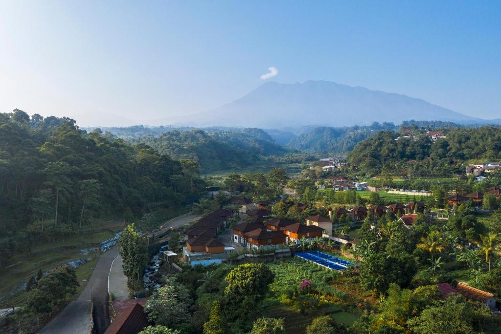 an aerial view of a village with a mountain in the background at JSI Resort in Puncak