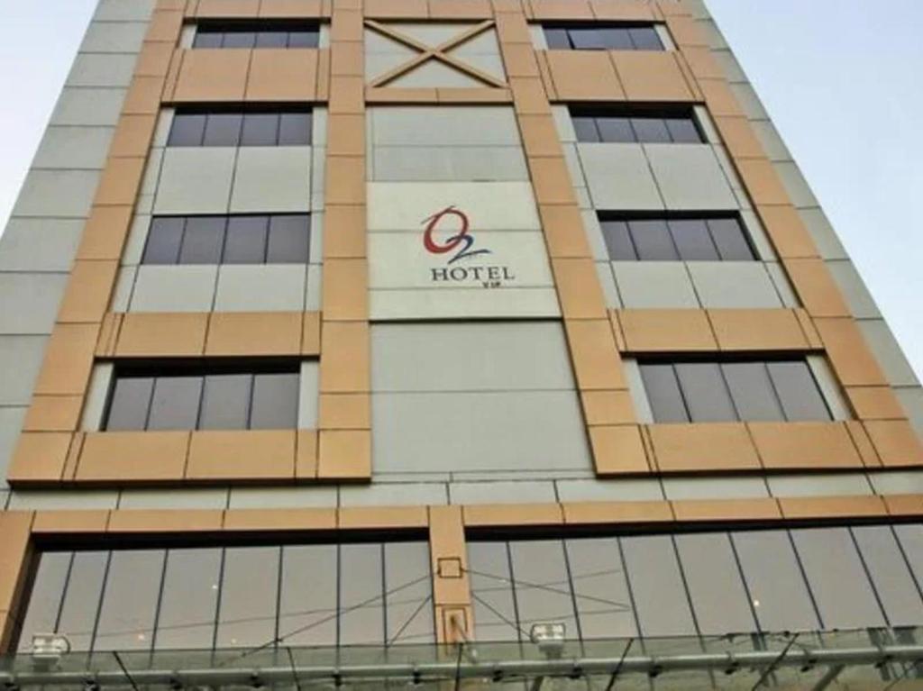 a building with a hotel sign on the side of it at Hotel O2 VIP in Kolkata