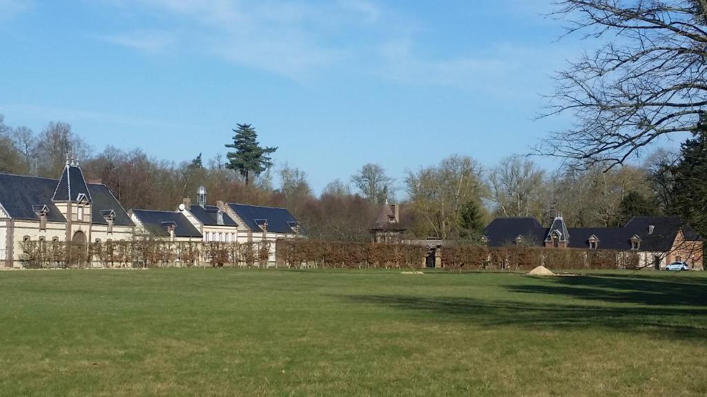 a large house with a fence in a field at Domaine de Coulonge 