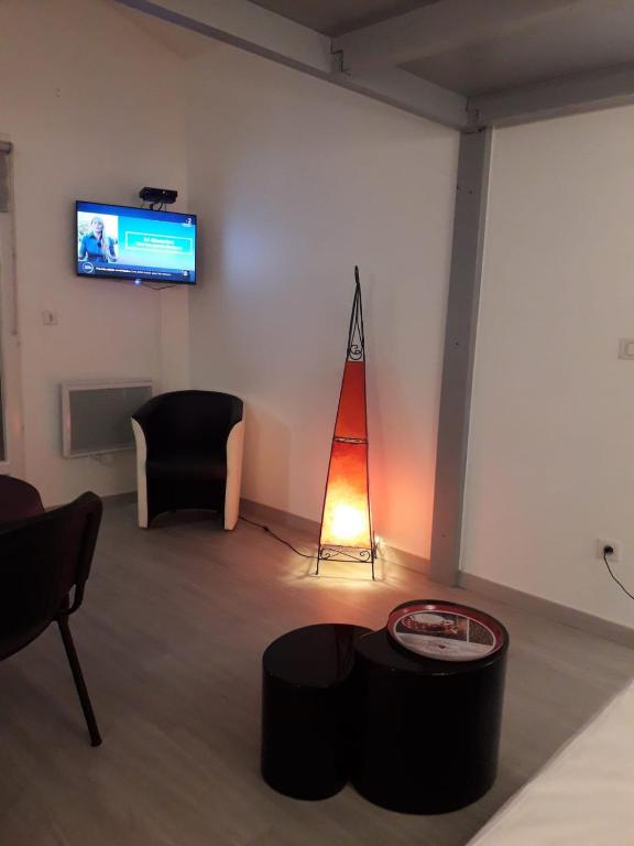 Una televisión o centro de entretenimiento en DORMIR A MONTAUBAN Logements Carreyrat Calme et Verdoyant