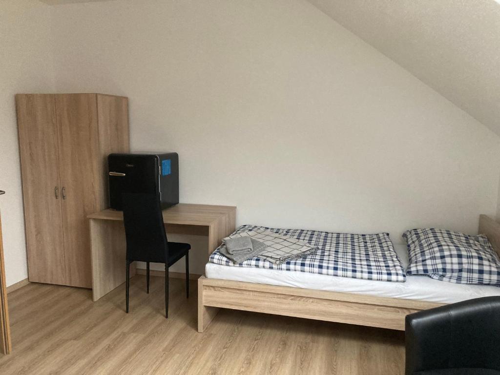 a bedroom with a bed and a desk with a television at Ubytování Na špejcharu, Želevčice in Slaný