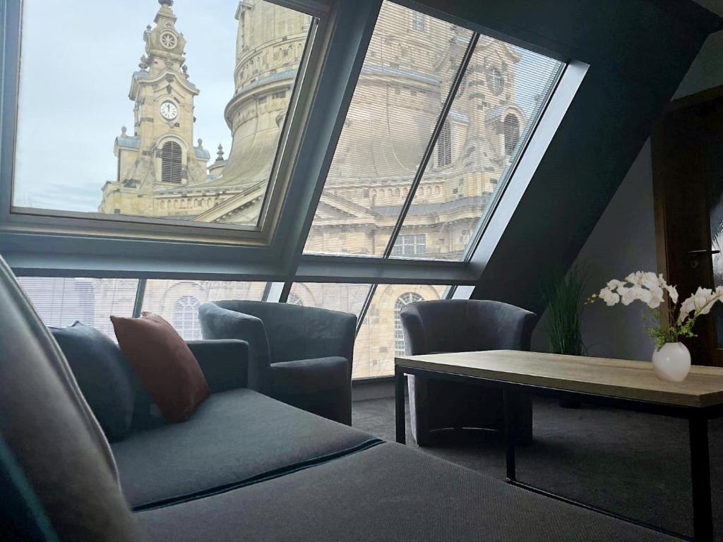 a room with a large window with a clock tower at Maisonette-Apartment An der Frauenkirche in Dresden