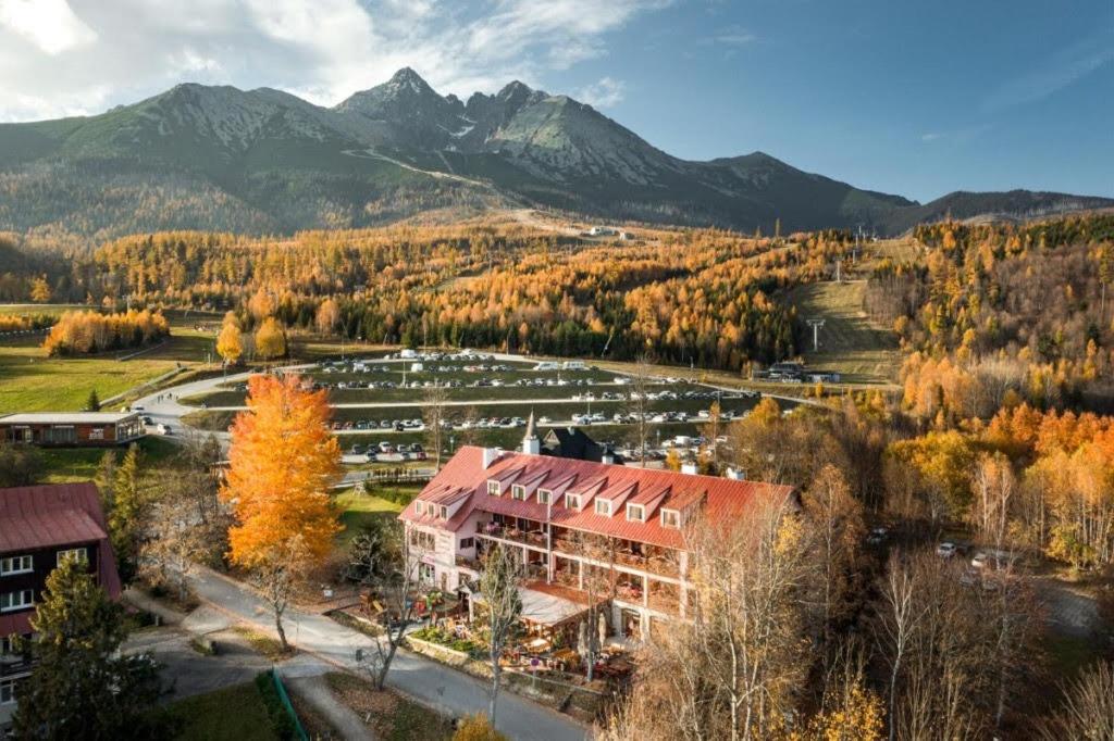an aerial view of a building with mountains in the background at Penzion Zora Family in Tatranská Lomnica