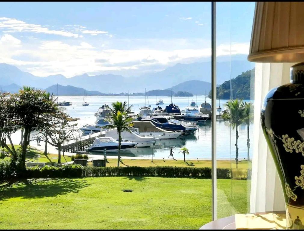 a view of a marina with boats in the water at Frente & Vista do Mar - Fasano Area, Porto Frade - Angra dos Reis, RJ Seafront View - Inside a Condo - Next to a 5-Star Hotel in Angra dos Reis