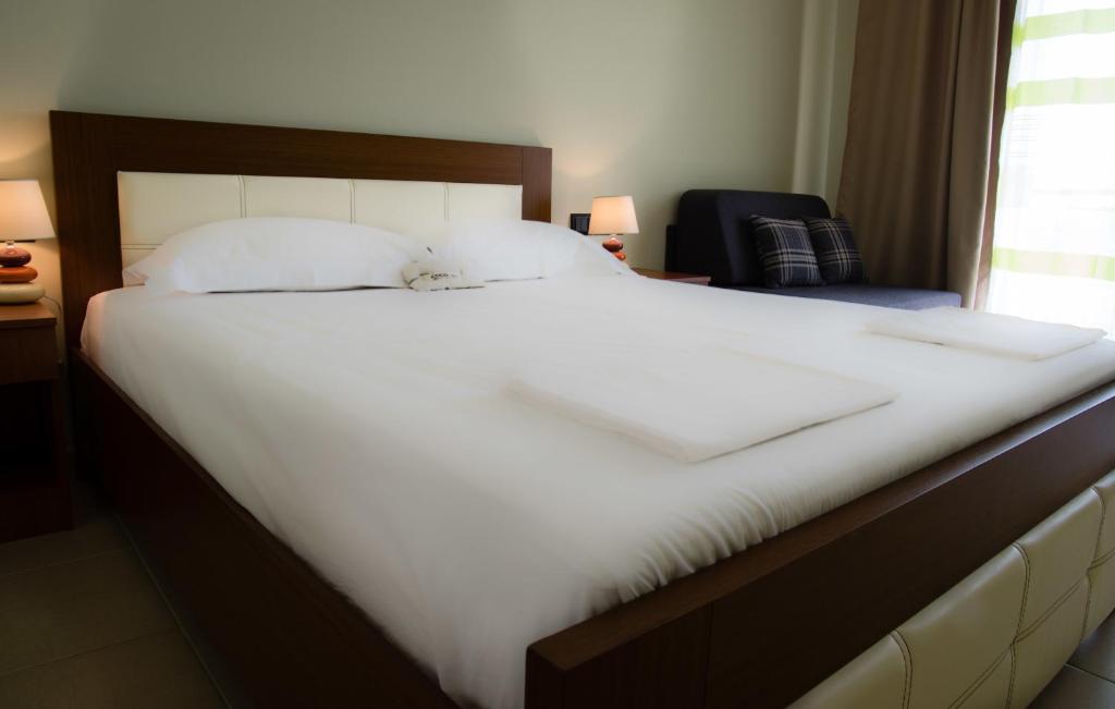 Postel nebo postele na pokoji v ubytování Ipsario Garden Hotel