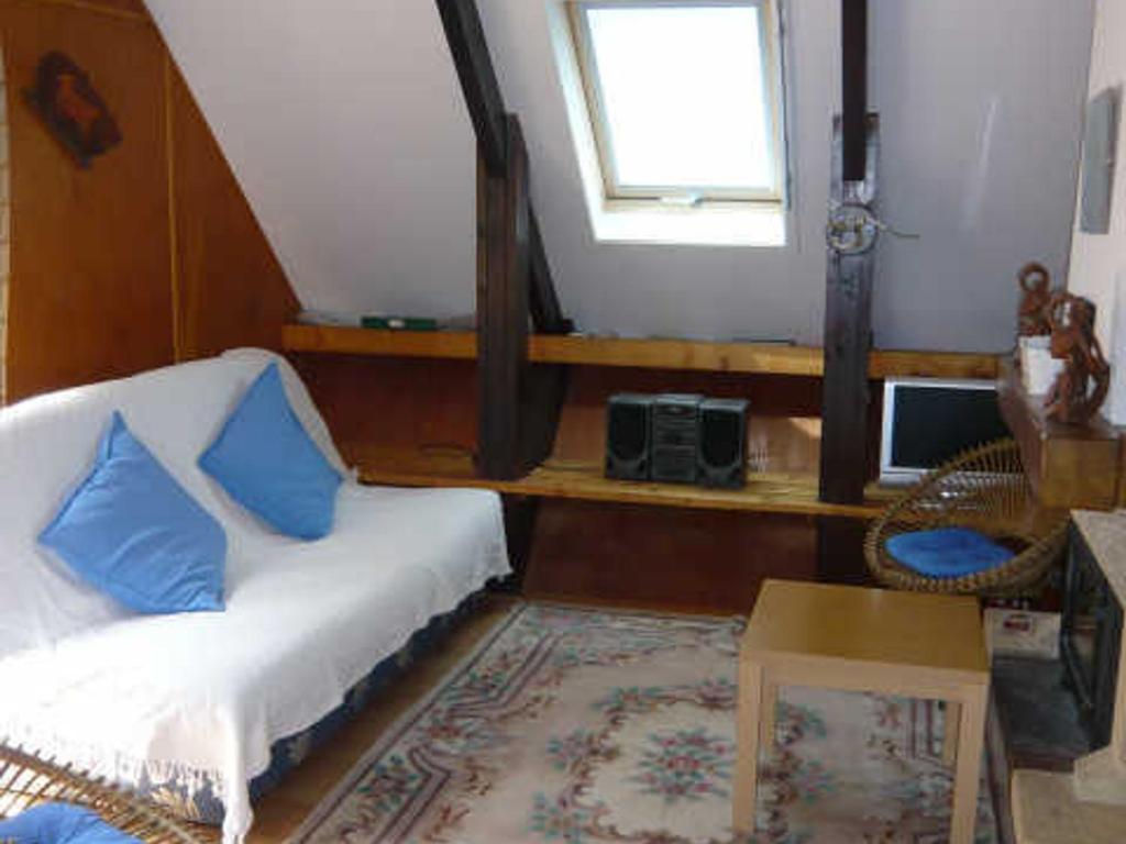 a bedroom with a bed with blue pillows and a window at Chalet Corrençon-en-Vercors, 2 pièces, 6 personnes - FR-1-515-55 in Corrençon-en-Vercors
