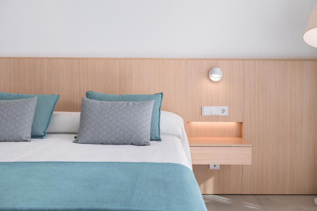 A bed or beds in a room at Petit Sagitario Adults only