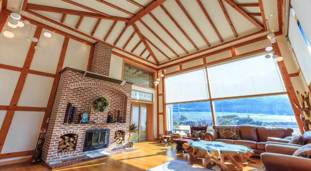 a large living room with a brick fireplace at ChungDam in Pyeongchang