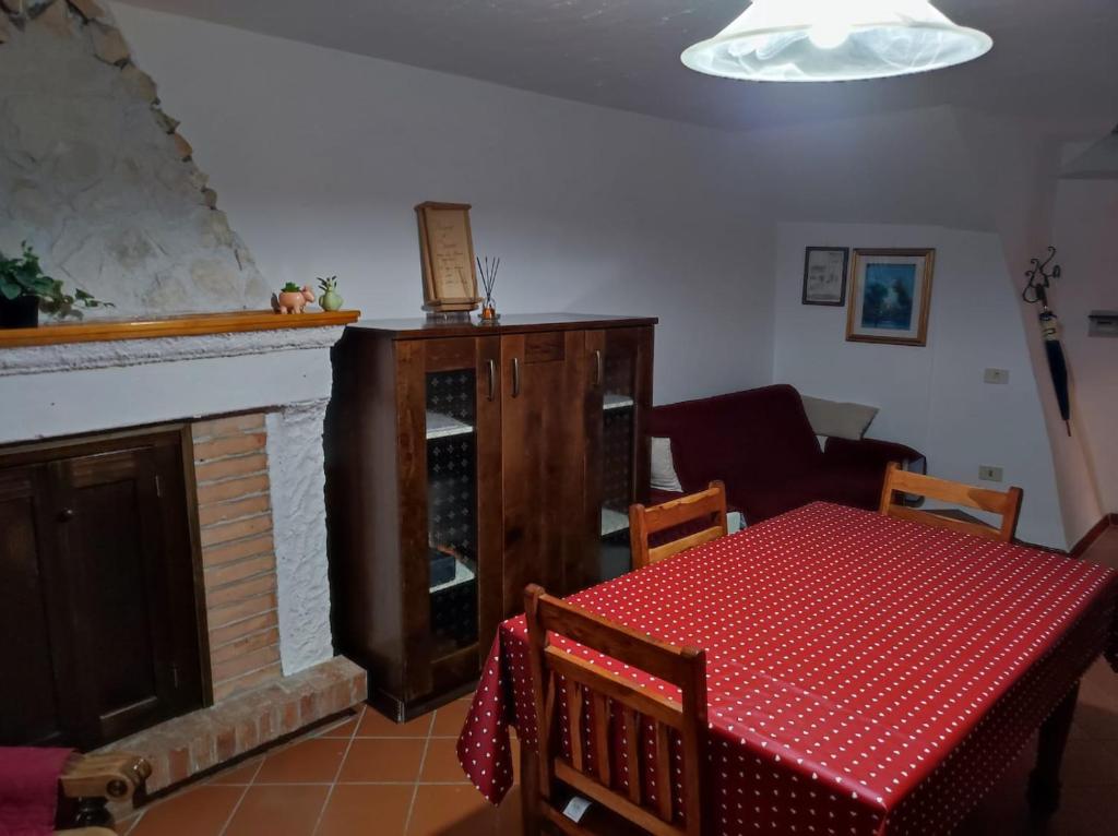 a living room with a table and a fireplace at Casa Scanno centro storico in Scanno