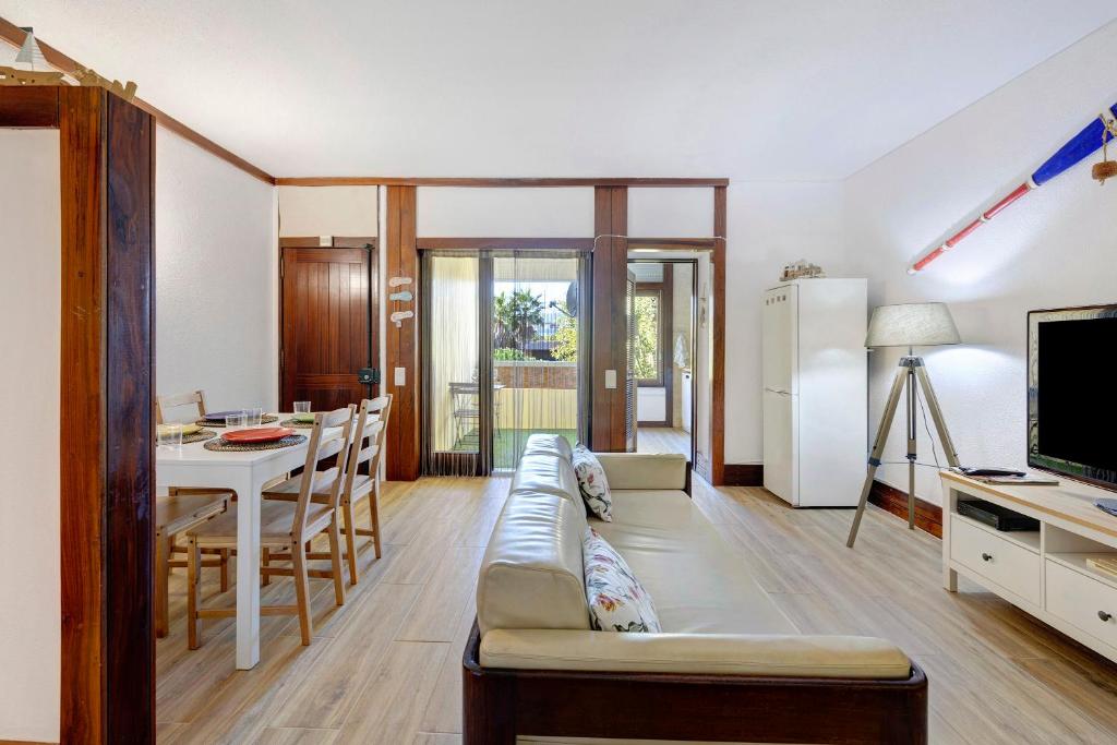 a living room with a couch and a table at Casa de Praia Tróia in Troia