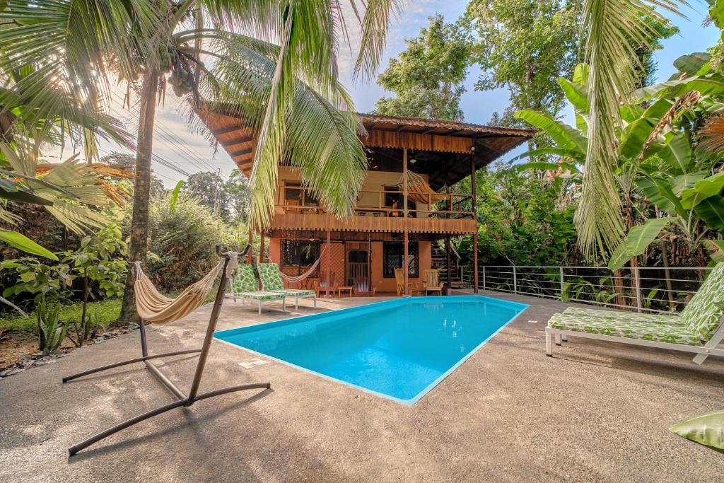 a villa with a swimming pool and a resort at Azania Oasis in Puerto Viejo